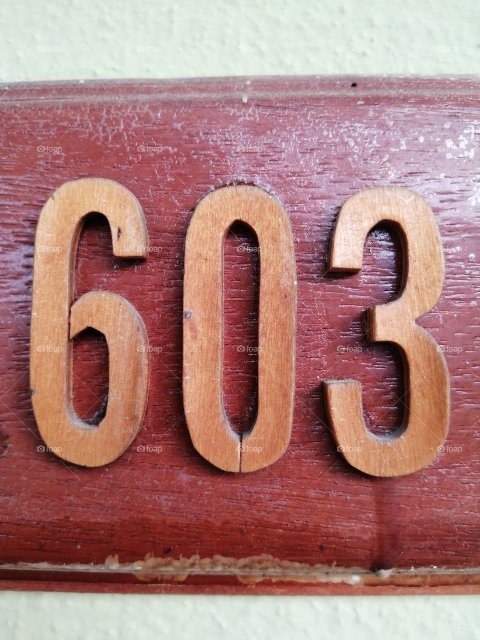 wooden numbers on a wooden red door