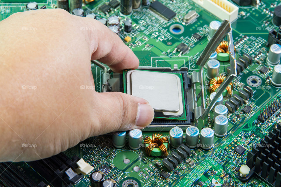 CPU in hand before installation into the motherboard