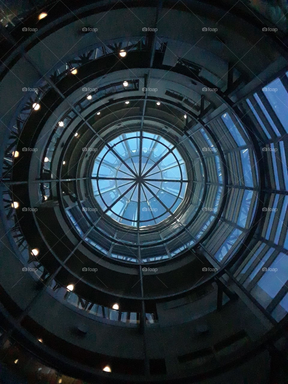 Upward view of the Hixin Leid Auditorim that showcases the beautiful assymetrical design through glass