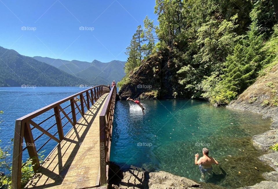 Boy diving off bridge at Lake Crescent Devil’s Punchbowl
