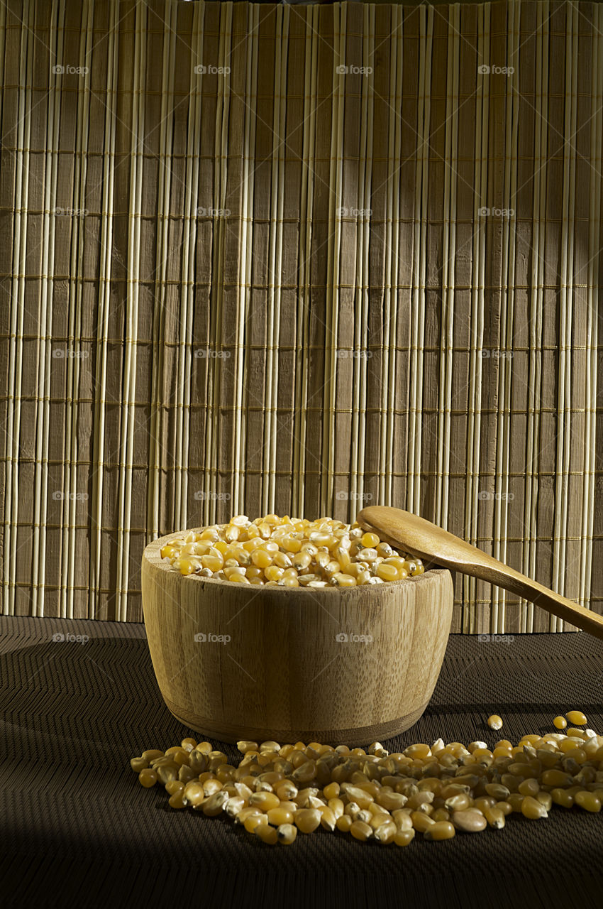 corn in a bamboo wood golden tones in rustic table