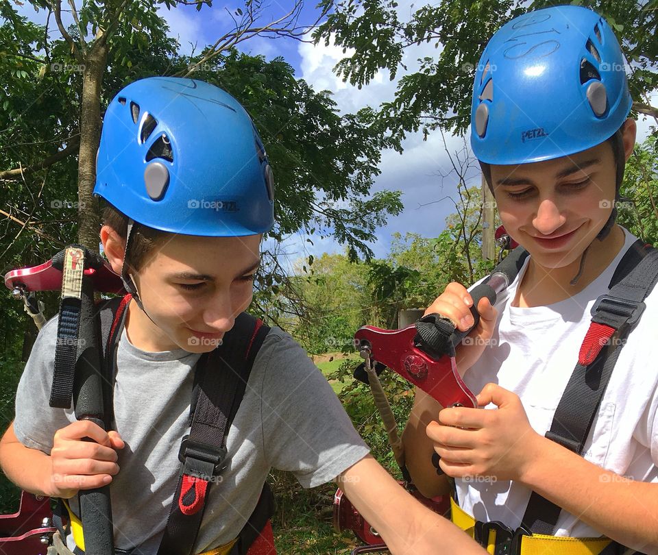 Brothers having fun together.  Getting ready to go zip lining in the mountainous rainforest of St. Kitts. 