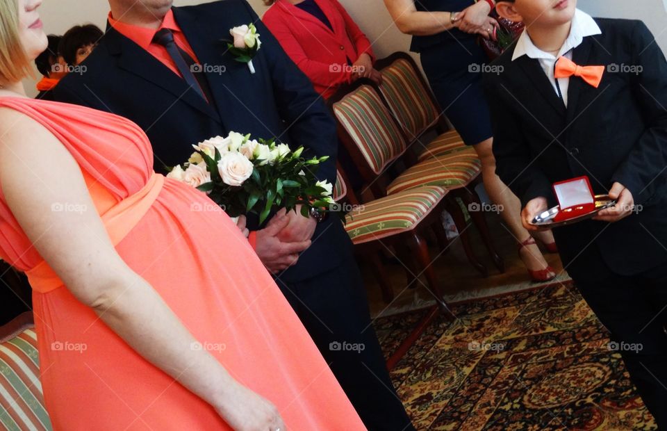 Boy holding weeding rings for his parents