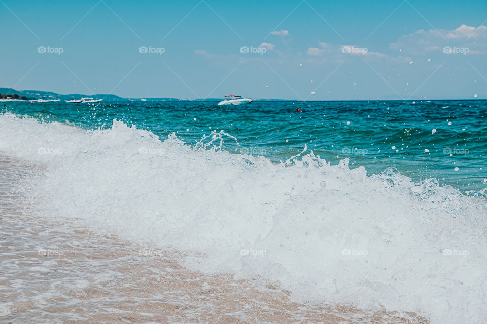 The foaming waves near the beach. Summer and vacation time.