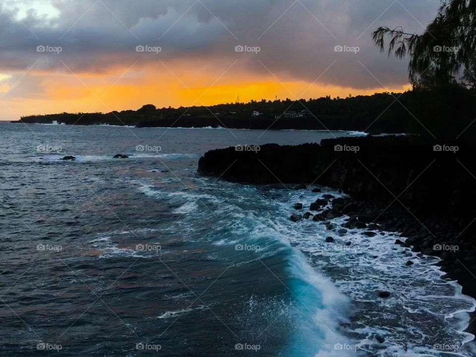 Sunset by a black sand beach