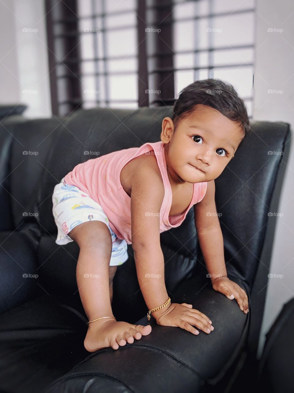 baby climbing on sofa