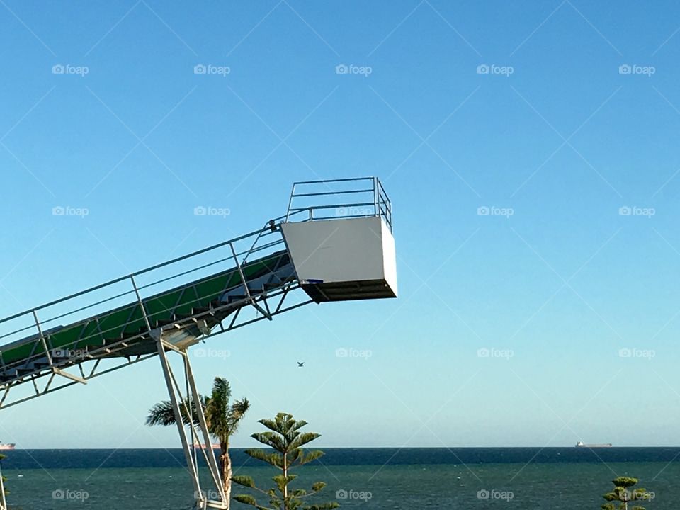 Crane lift against a clear blue summer sky blue and white 