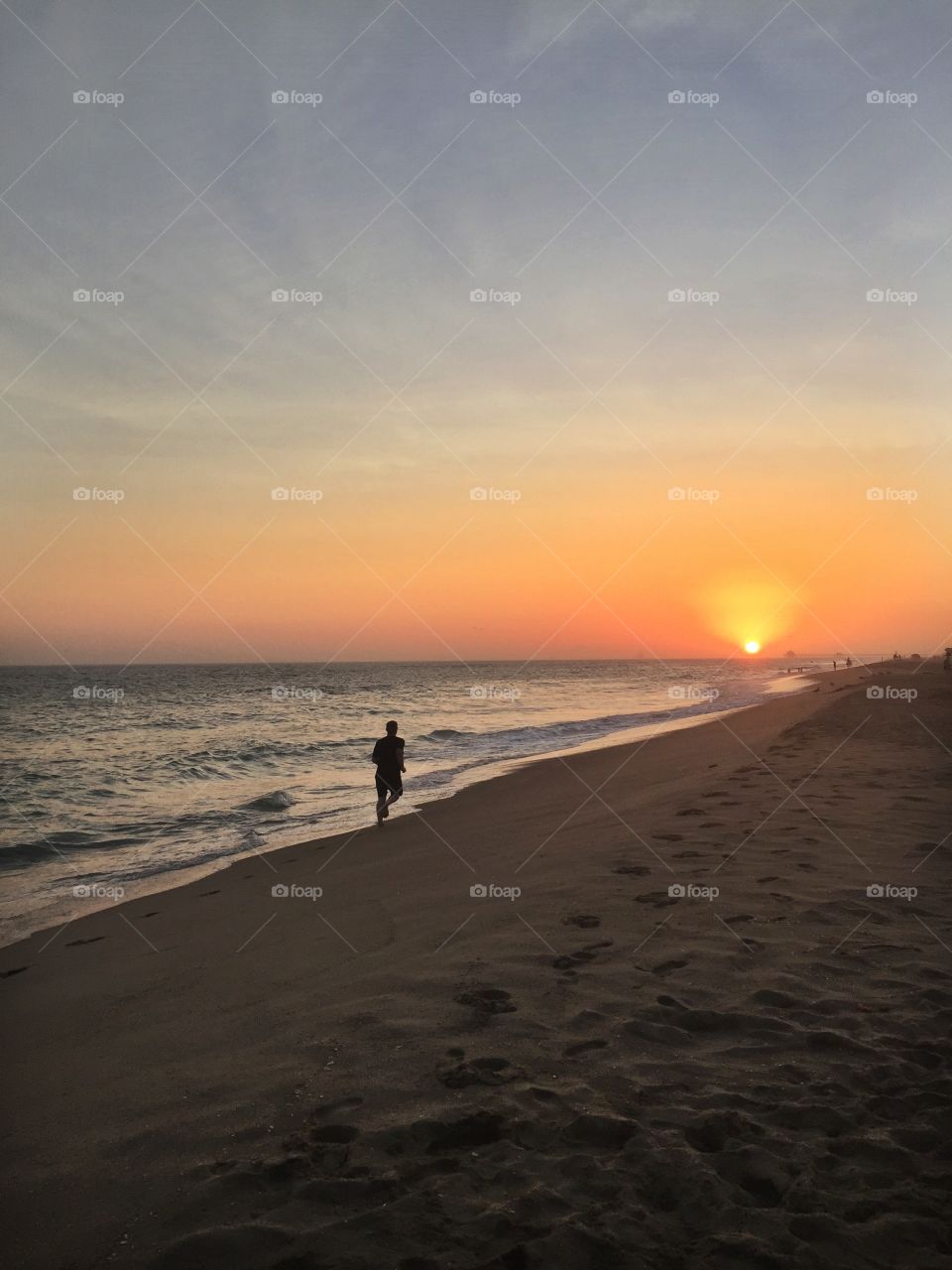 Running on the beach at sunset 