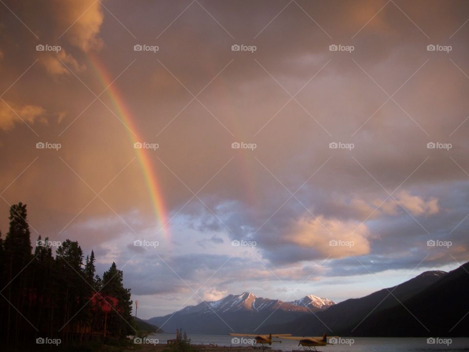 Seaplanes, a lake, mountains, and a rainbow 
