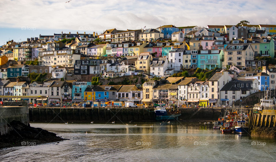 colourful fisherman's cottages and buildings surrounding Brixham Harbour in Devon UK