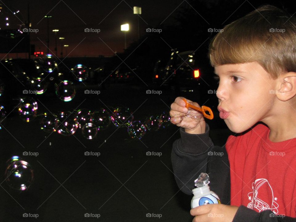 Boy blowing bubbles