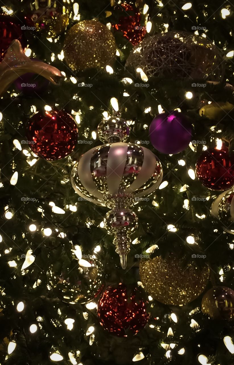Silver ornament on green tree