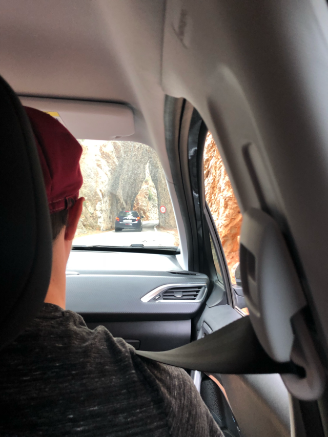 Mountain exploring in car back seat view 