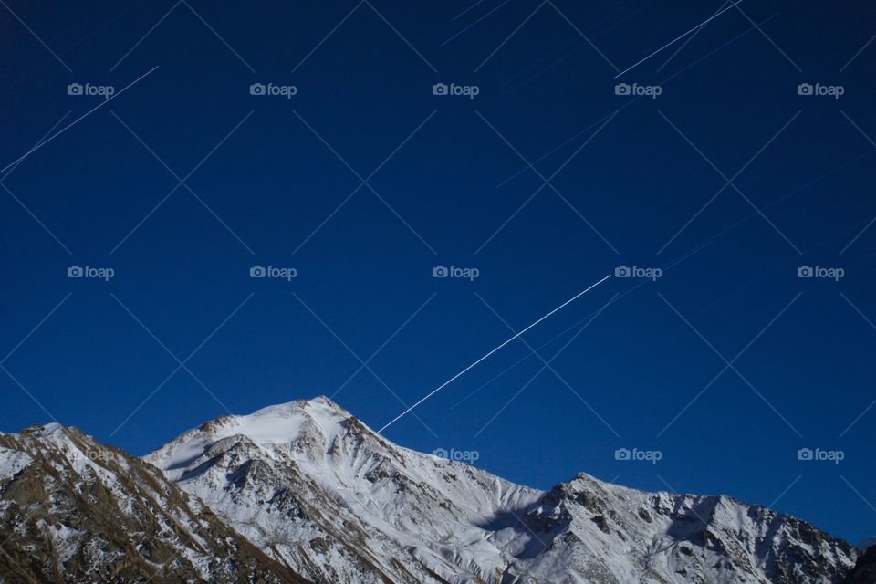 Star trails in snow mountains 