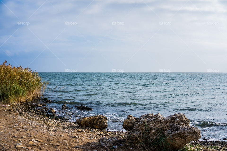 Seashore with stones in the sand