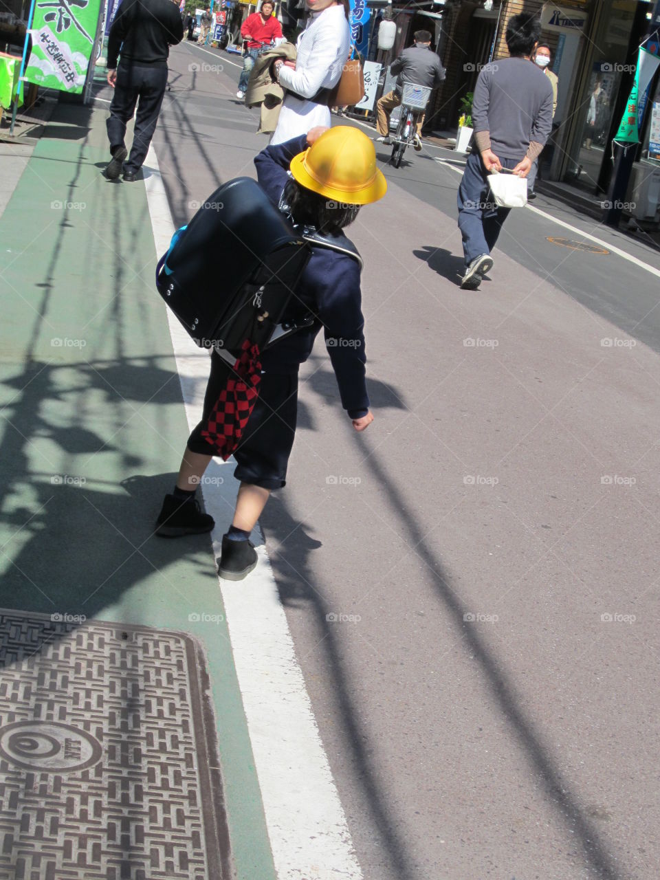 Japanese Schoolboy in Nakameguro, Tokyo.  Little Boy in Traditional School Uniform.  Child Walking through City.