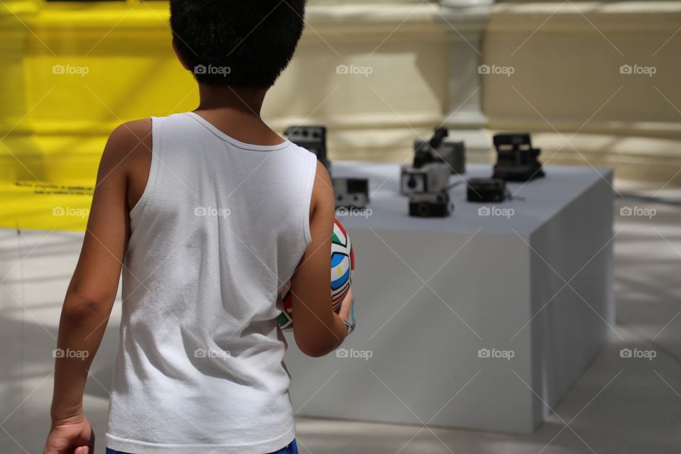 Boy with football looking at cameras 