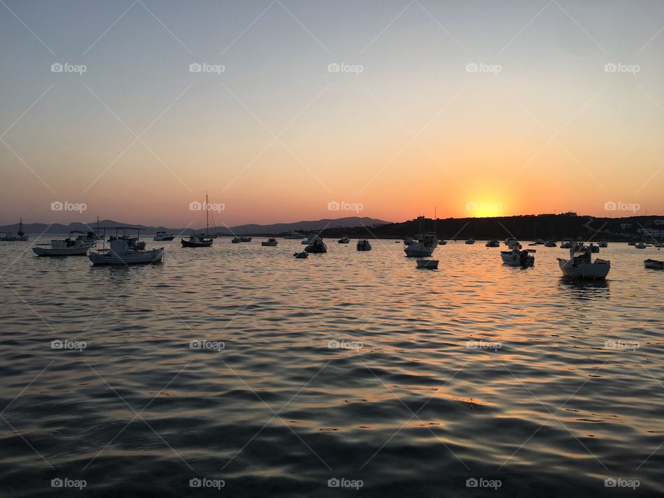 Greek sunset , waterfront harbor, beautiful sail boats