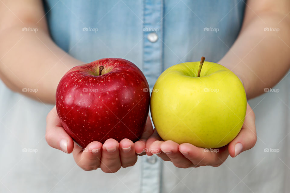 Hand holding red and yellow apple