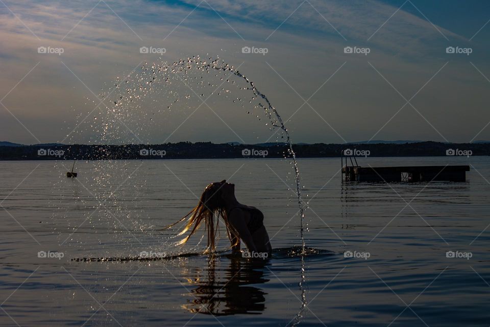 A circle of water around this woman in the water.
The silouette,the beauty,the water  its  beautiful together.