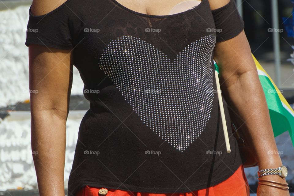 A closeup of a large heart shaped embroidery on the front side of woman’s outfit