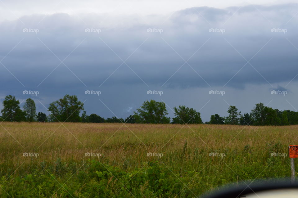 Dark clouds over field