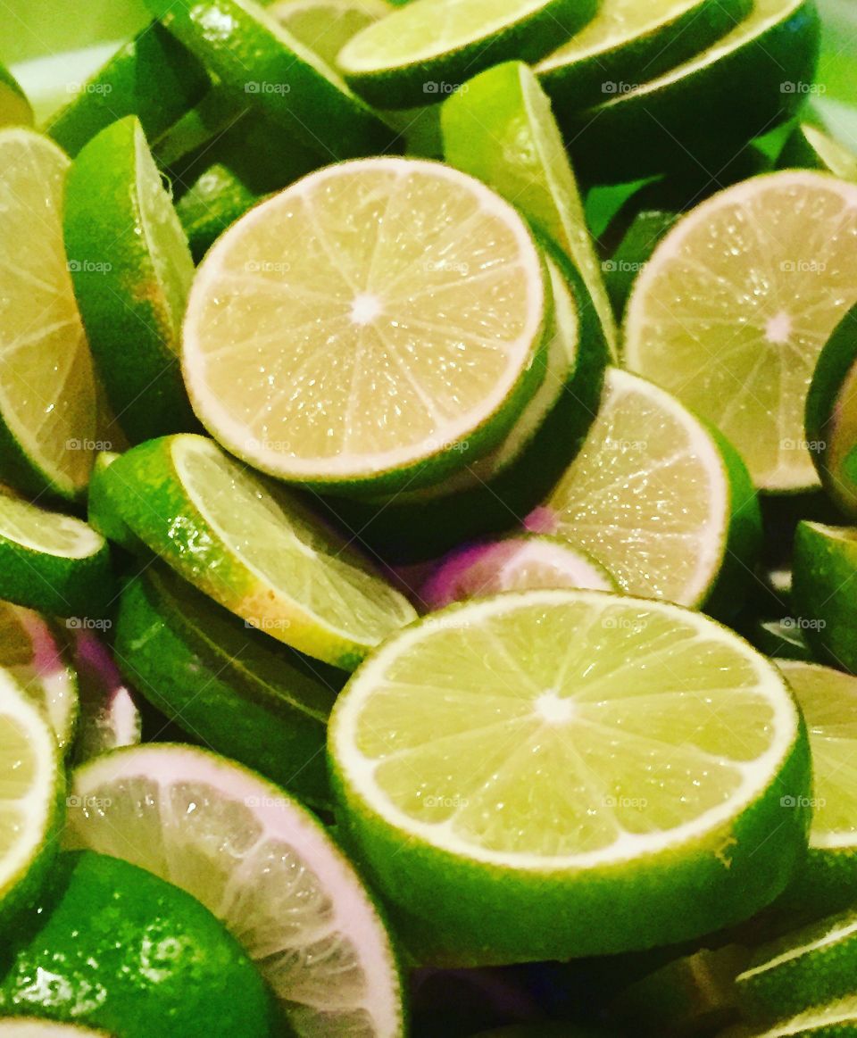 Sliced bright green limes to garnish drinks.