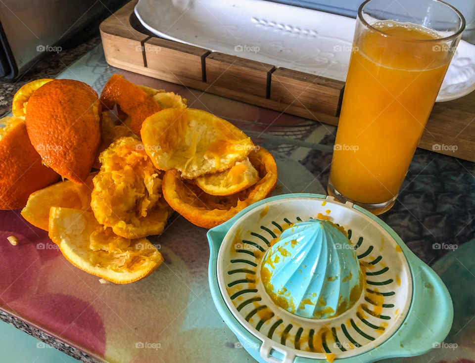 Preparing freshly squeezed by hand orange juice 