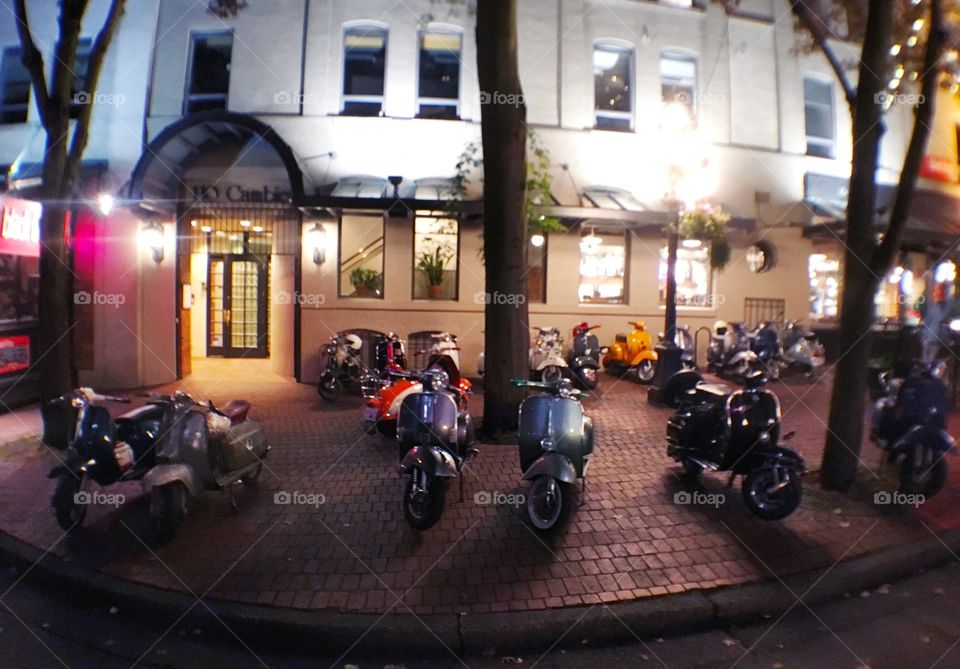 Vintage scooters in Vancouver's Gastown at night 