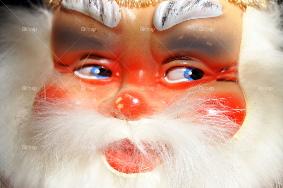 Close up of a vintage German Santa dolls face.