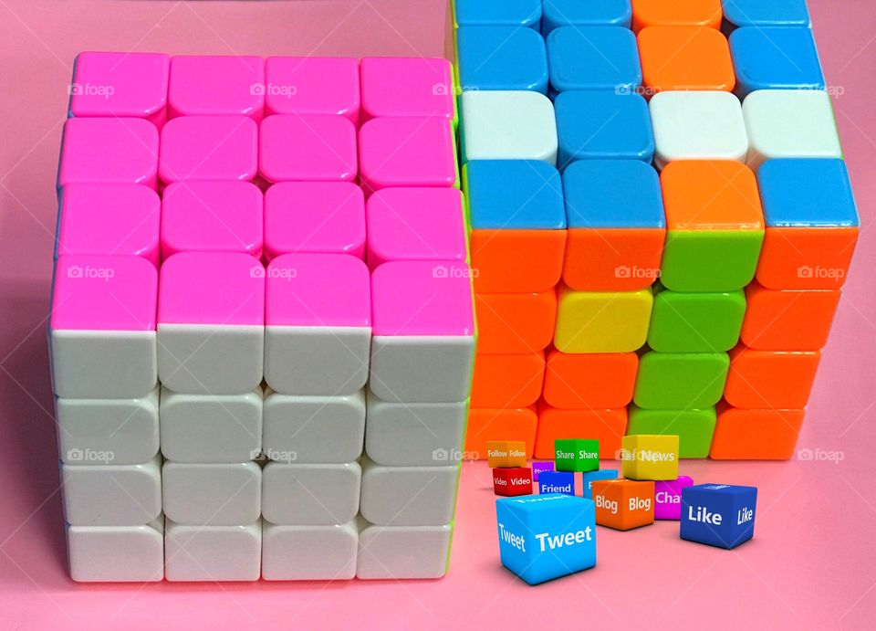 Colorful cube puzzle pink white red orange blue and social media icons pink background 