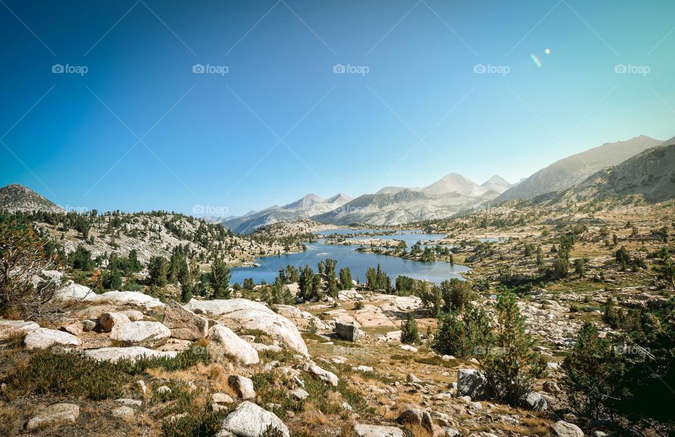 Marie Lake in the California wilderness is surrounded by rocks and mountains.