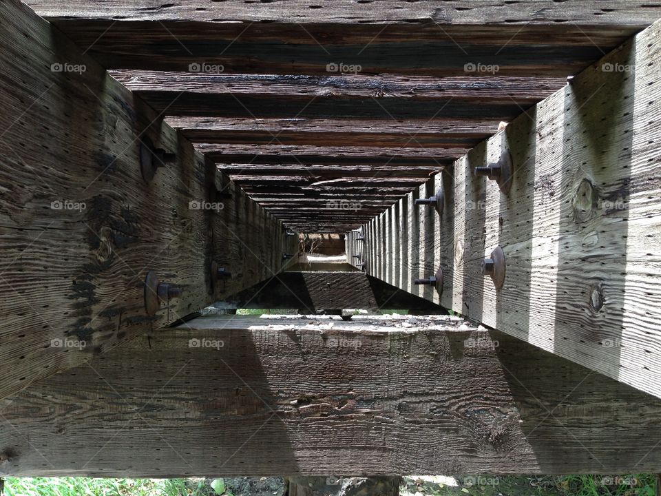 Railroad crossing. Railroad tracks photo taken under a bridge.