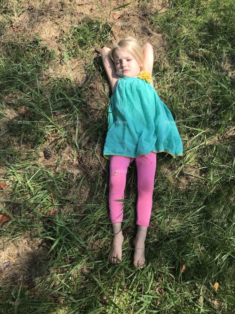 Blonde Girl Relaxing in the Warm Summer Grass