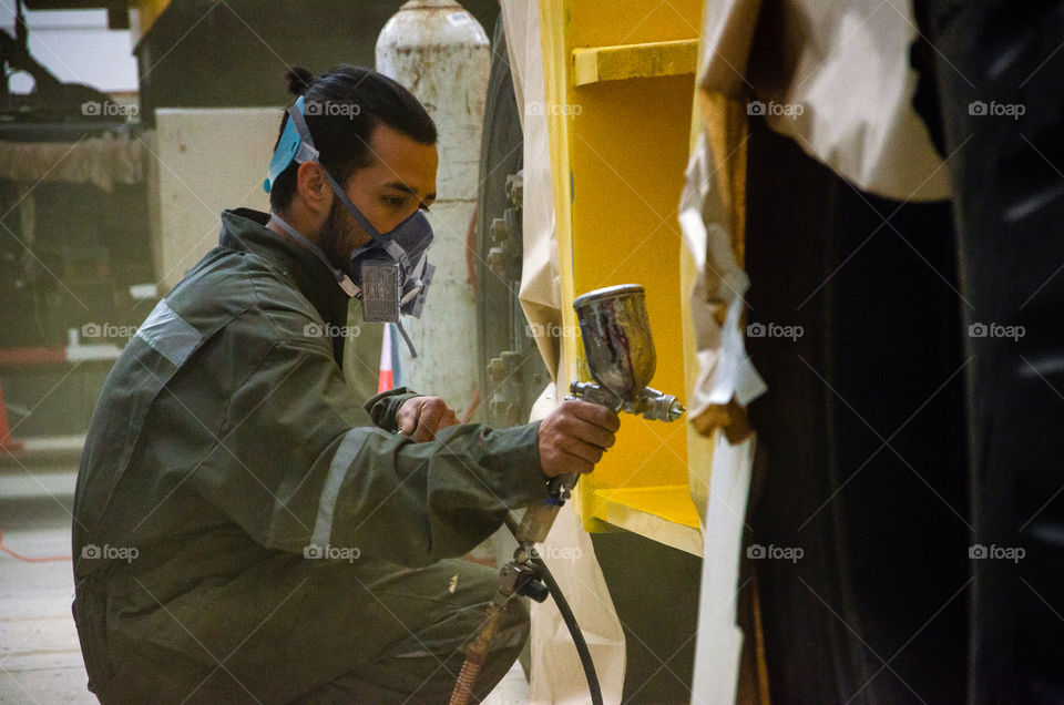 man painting a machine