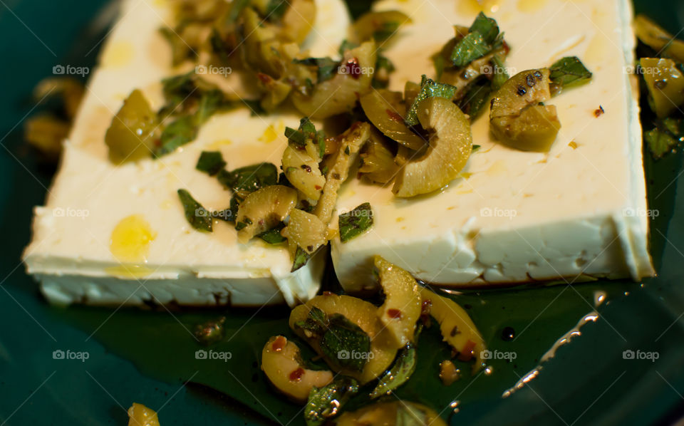 Green olives with feta and fresh oregano in olive oil and basaltic vinegar 