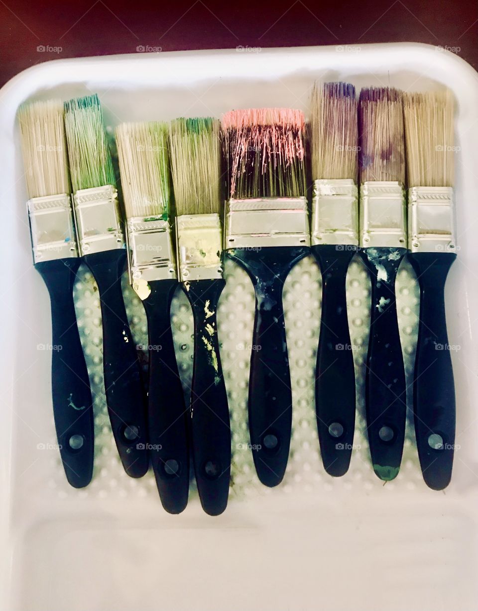 Paintbrushes with different colors of paint on them