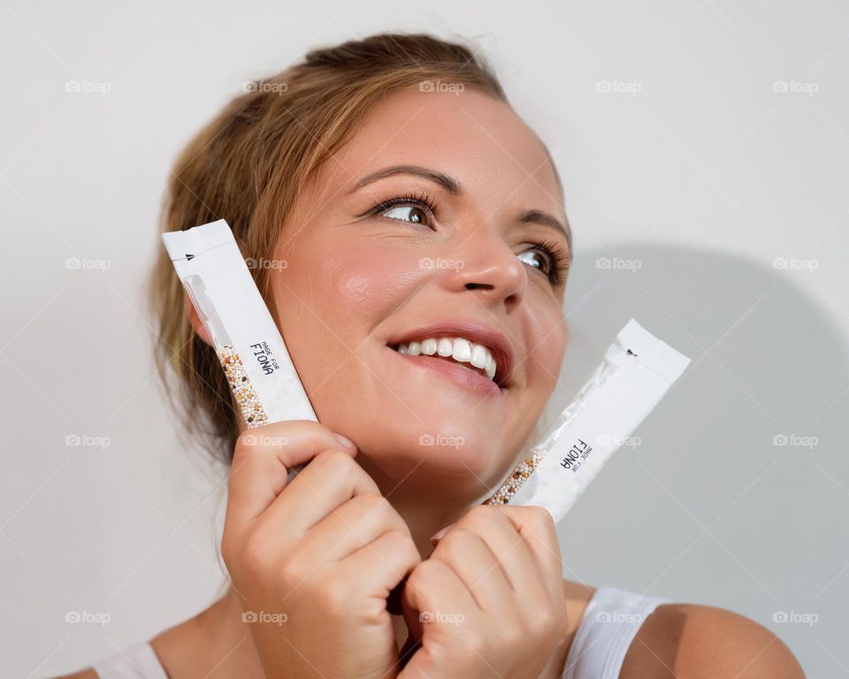 Portrait of a young woman with products