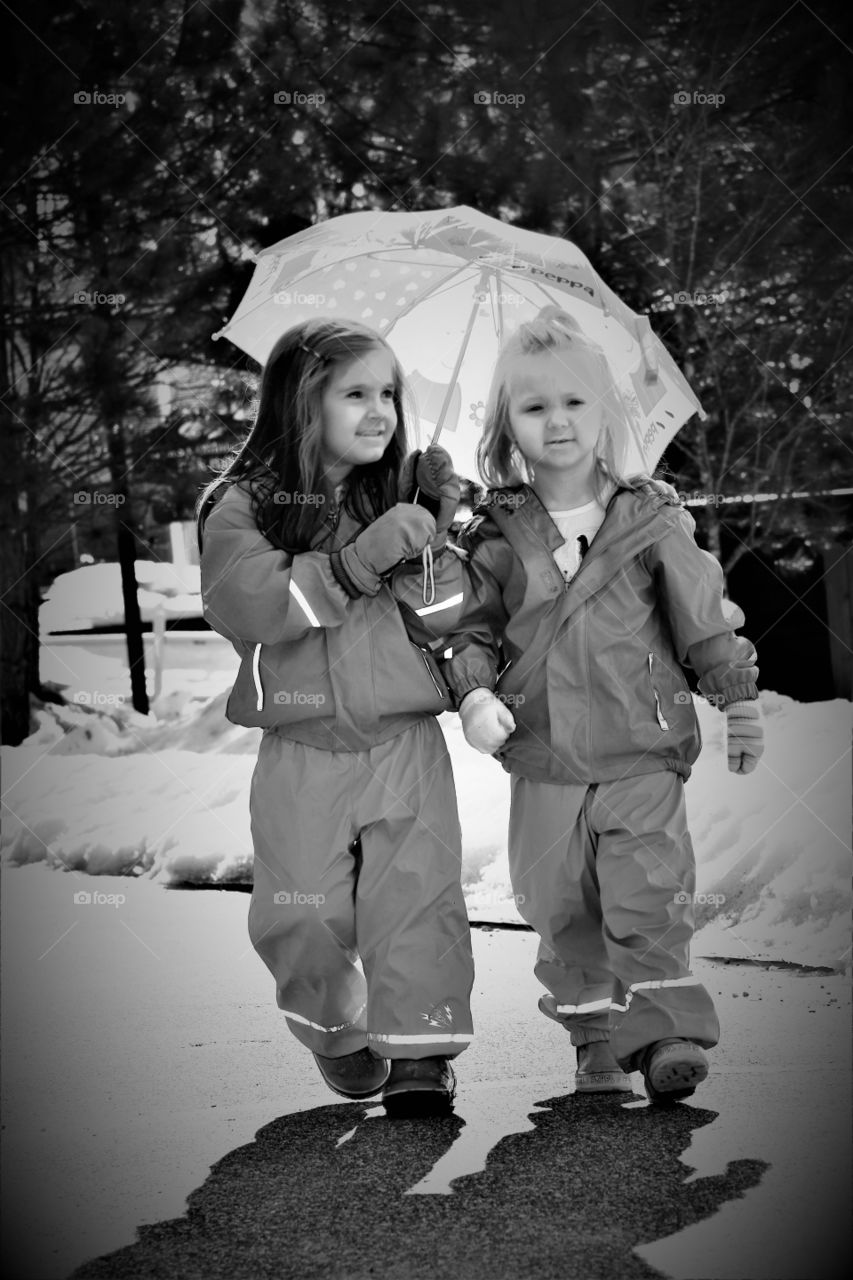 girls walking with rain gear on