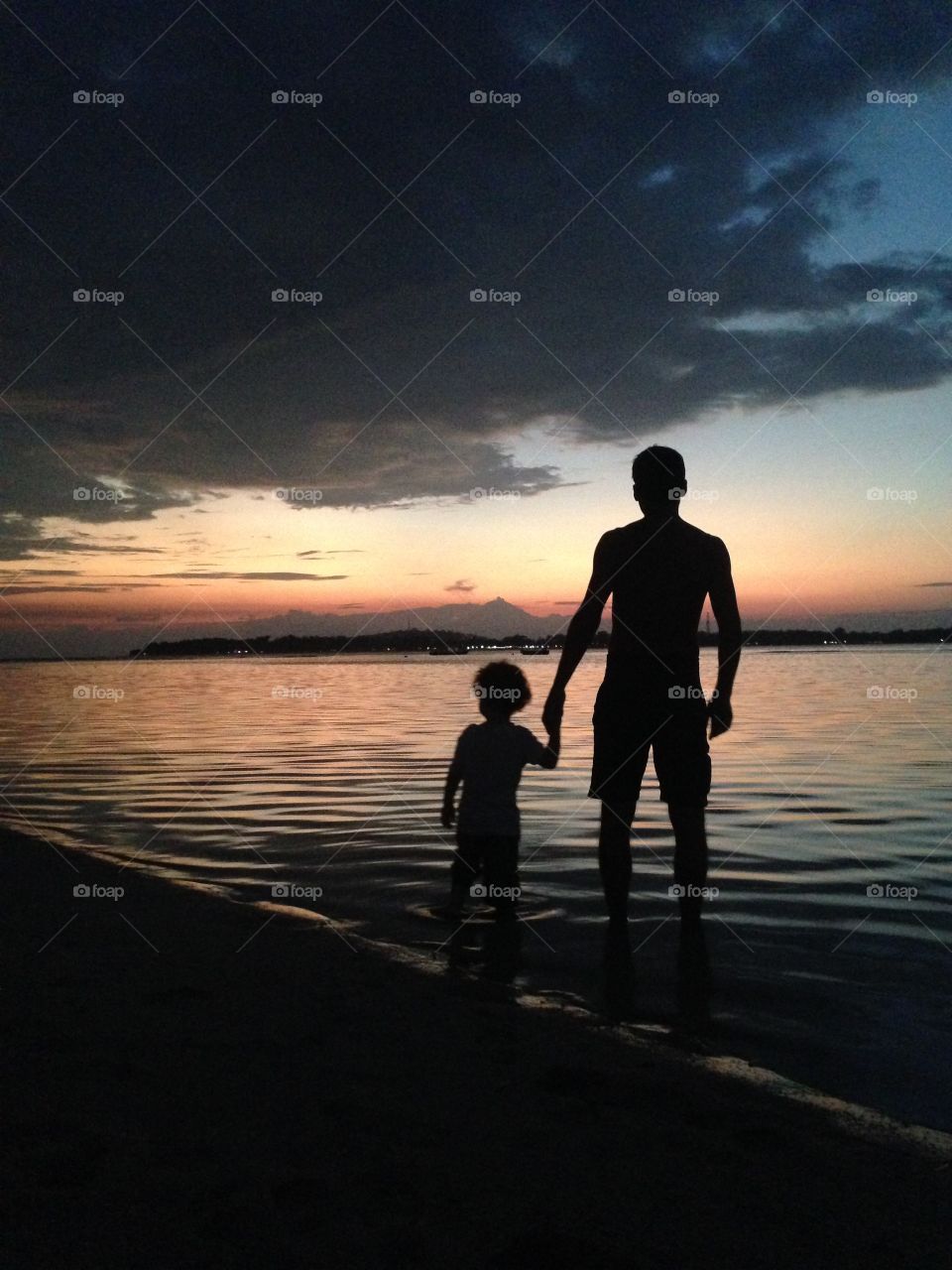 a father and his son at sunset
