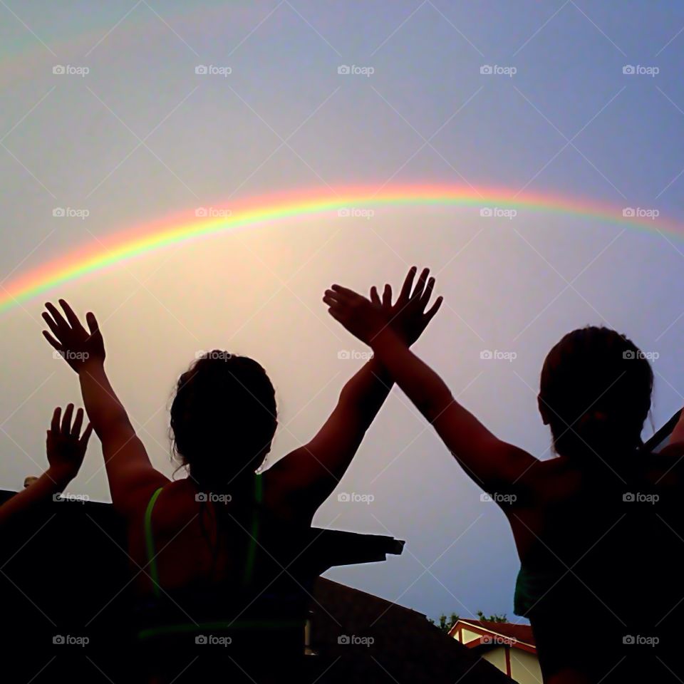 Rainbow rejoice. Girls celebrating rainbow
