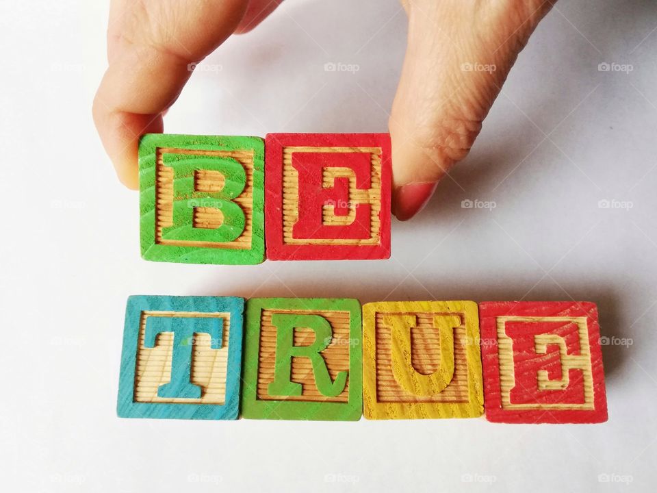 Written be true with wooden cubes