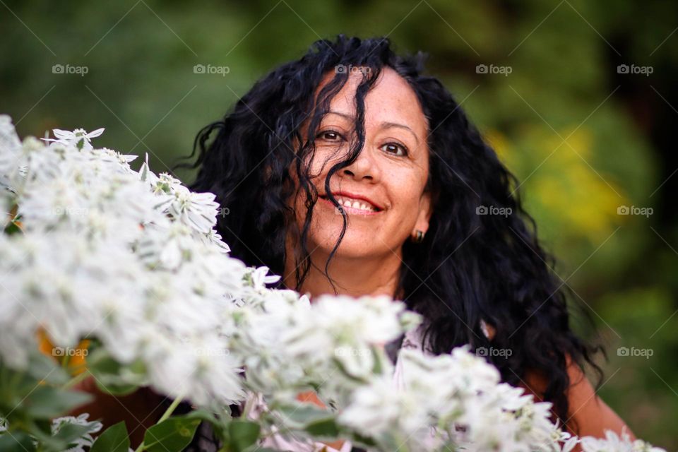 Middle-aged happy woman with dark curly hair