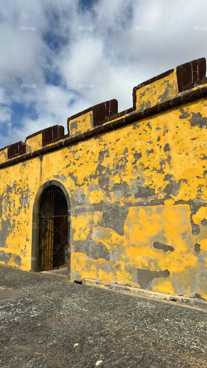 Above the seafront a vibrant, ochre wall of the ancient Fortaleza de São Tiago built to defend Funchal from pirates.