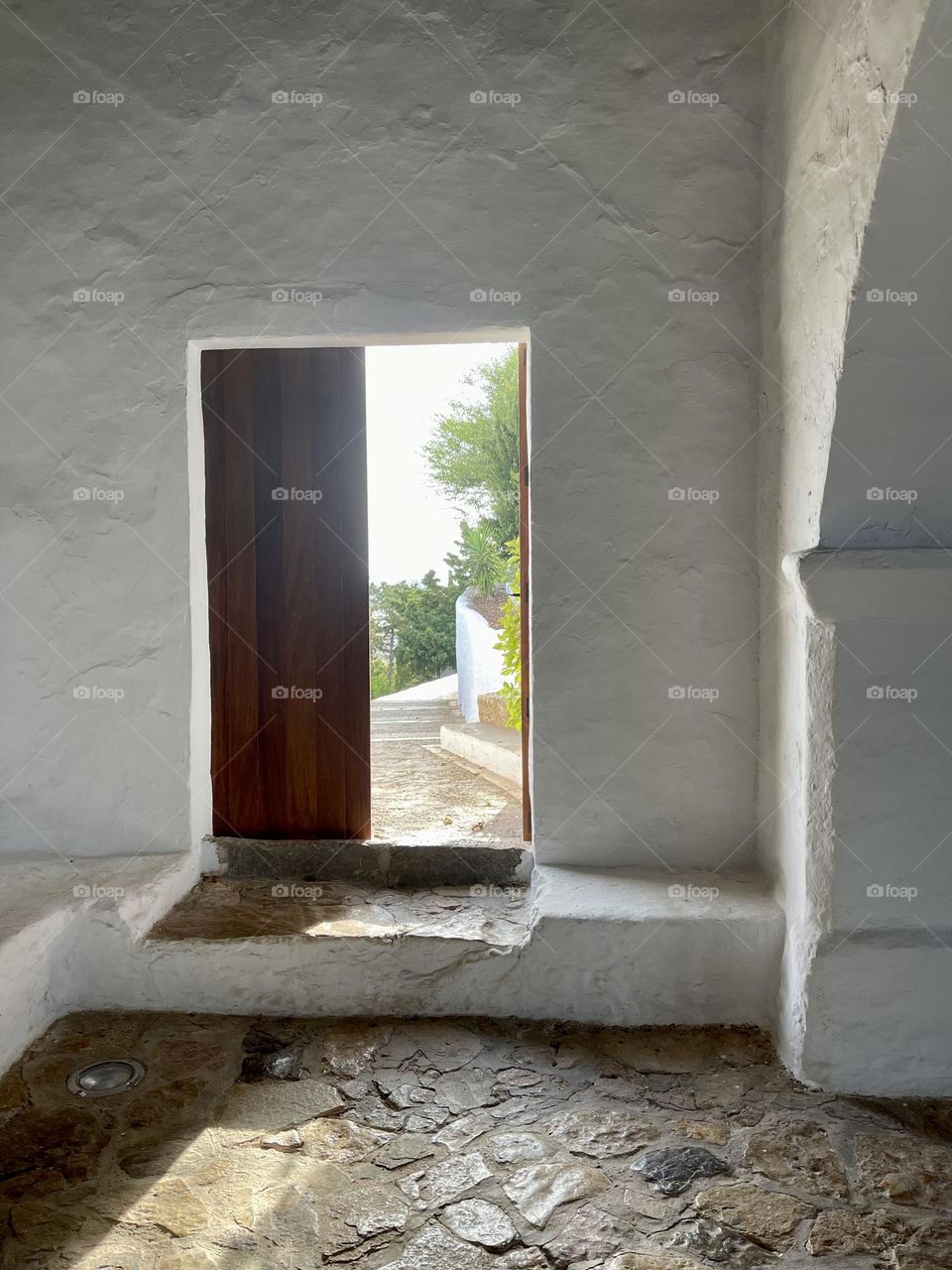 Wooden door half opened to an internal garden patio; Santa Eulalia des Riu, Ibiza, Eivissa, chicche of Santa Eulalia des Riu, Puig de Missa 