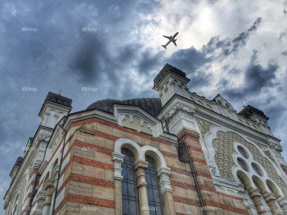 The Sofia Synagogue . Cloudy day with airplane in the sky over the Sofia Synagogue, Bulgaria