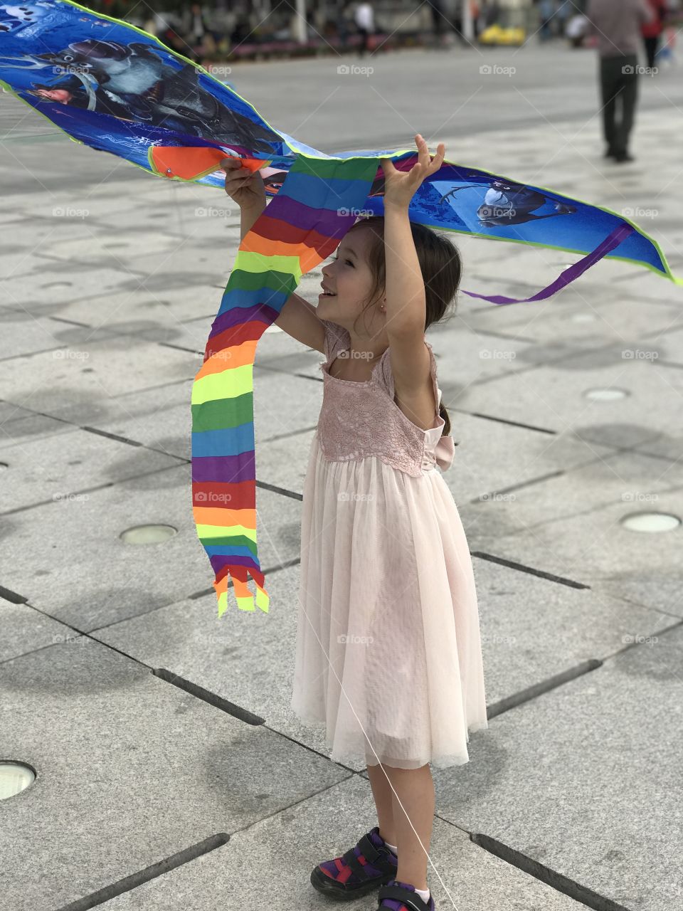 Girl holding colorful kite