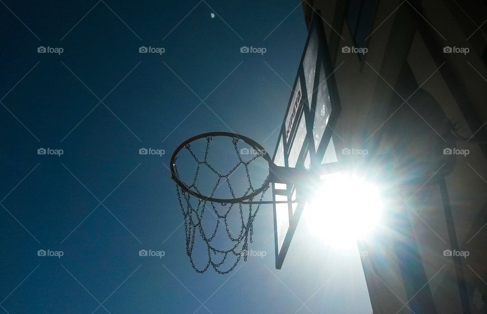 sunlight and street basketball rim