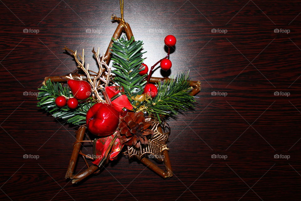 Christmas wooden star with decorations on a wooden table