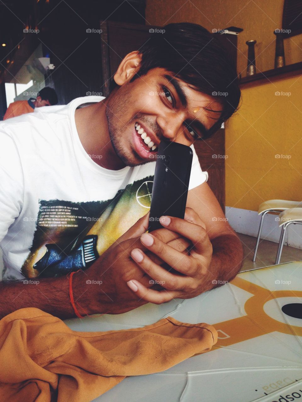 Indian man holding smartphone